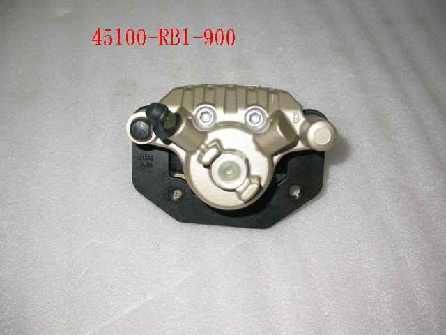 Суппорт тормозной передний левый с колодками